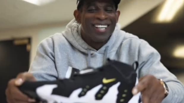 Deion Sanders holding Diamond Turf 3's for LeBron James